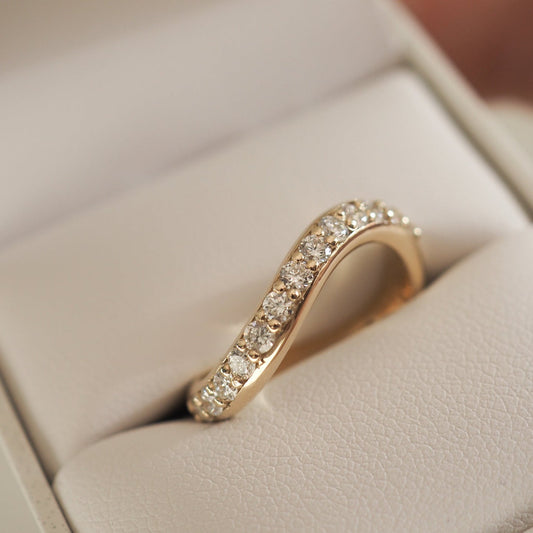 Curved Wedding Band Featuring 1.65 TCW Oval Moissanite