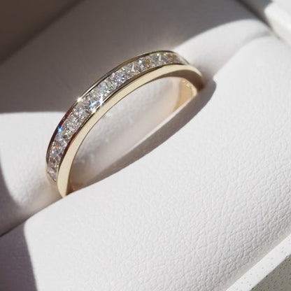 Channel Wedding Band Featuring 0.90 TCW Princess Moissanite